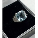 Fine platinum Aquamarine and diamond ring central stone measures approx 11mm by 11mm set with 5 smal