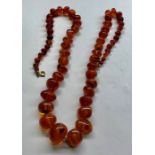 Vintage Amber bead necklace largest bead measures approx 20mm by 16mm total length approx 63cm long