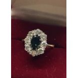 Fine diamond and sapphire ring set with central stone with diamonds around dimonds ech measurs appro