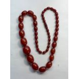 Fine Cherry amber / bakelite necklace good internal streaking largest bead meaures approx. 27mm by 2