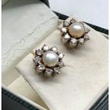 Pair of Diamond and Pearl earrings set with central pearl that measures approx 5mm dia with 9 diamon