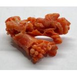 Antique carved coral brooch measures approx 48mm by 35mm carved with grape vine and bird