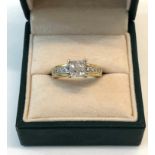 18ct gold diamond ring set with 4 baguette diamonds each measures approx 3mm sq with 4 diamonds each