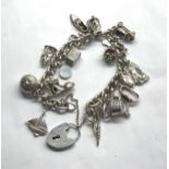Vintage silver loaded charm bracelet with charms Stamped sterling silver on heart padlock clasp