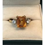 An 18ct gold yellow sapphire and diamond ring 4.70ct sapphire set with diamond each side weight 5g