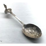 Large embossed antique silver spoon has a chicken finial with street scene possibly dutch hallmarked