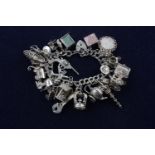 Silver charm bracelet with charms Assay stamps for London 1975. Stamps both on padlock clasp and end
