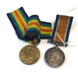 WW1 medal pair with original ribbons named 106097 Private J Wilson M.G.C