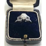 platinum and diamond ring et with large central diaond that measures approx 6mm dia with baguette