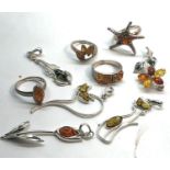 Selection of silver and amber jewellery rings pendant etc