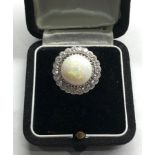 18ct white gold diamond and opal ring the central opal measures approx 14mm dia with diamonds around