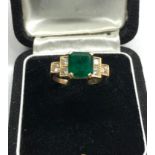 18ct diamond and emerald ring central emerald measures approx 8mm by 8mm with diamonds either side