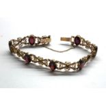 Vintage 9ct gold and garnet bracelet measures approx 19cm by 1.2cm wide fully hallmarked weight 14.