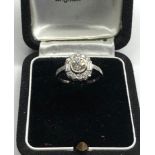 Platinum and diamond cluster ring central diamond measures approx 5.5mm dia set with diamonds around