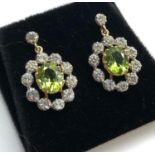 Fine diamond and peridot earrings peridot measures approx 8.5mm by 7mm with diamonds around drop