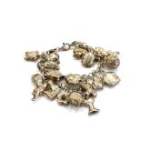 Silver charm bracelet measures approx. 17cm in length. item is in pre-worn, vintage condition