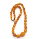 Egg yolk amber bead necklace graduated beads largest measures approx. 17mm by 13mm weight 15.5g