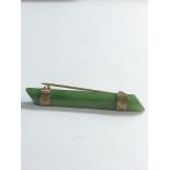 Jade brooch with gold mounts measures approx 50mm by 7mm good condition