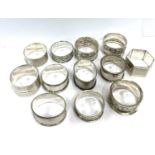 12 Various silver napkin rings 220g