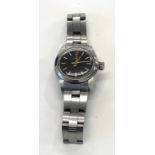 Vintage ladies stainless steel Rolex Oyster perpetual black dial watch in working order but no