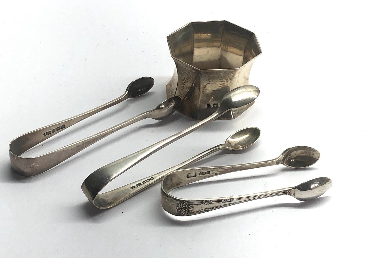 Selection of silver sugar tongues and a silver napkin ring weight 77g
