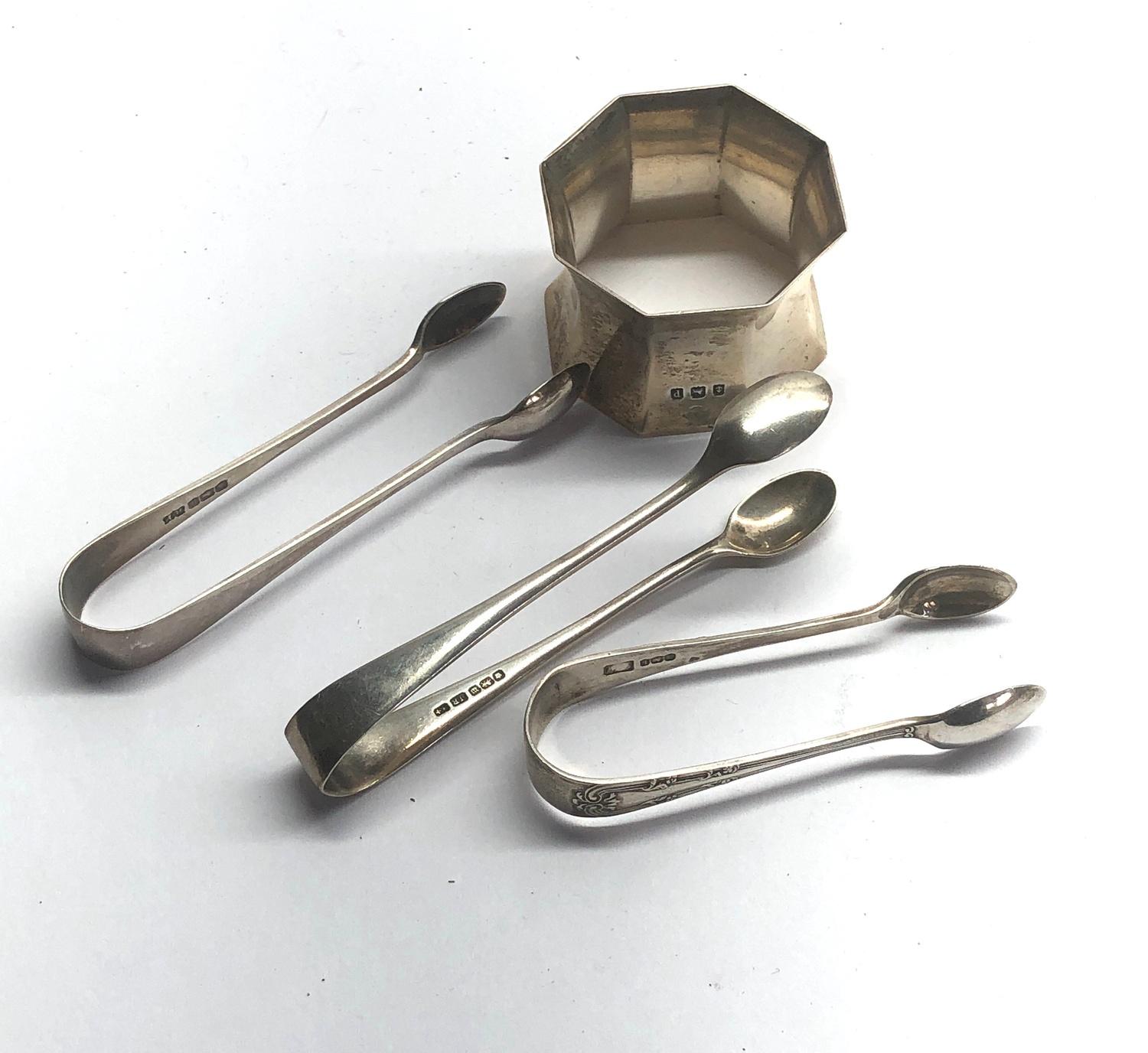 Selection of silver sugar tongues and a silver napkin ring weight 77g - Image 2 of 2