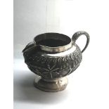 Antique silver Asian embossed milk jug measures approx height 7.2cm by 11cm wide please see images