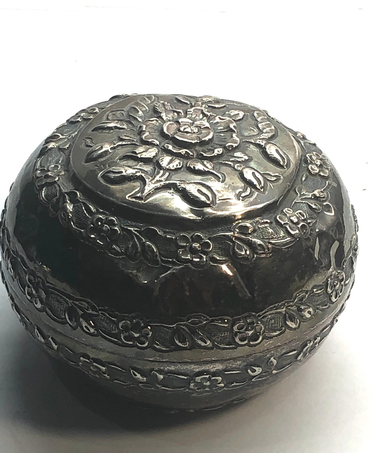 Asian silver lidded bowl floral embossed design measures approx 9.2cm dia not hallmarked but has
