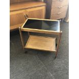 Retro teak two tier tea trolley, one leg damaged as shown in images