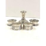 Selection of silver hallmarked napkin rings and a silver candle stick approximate weight 122.5g,