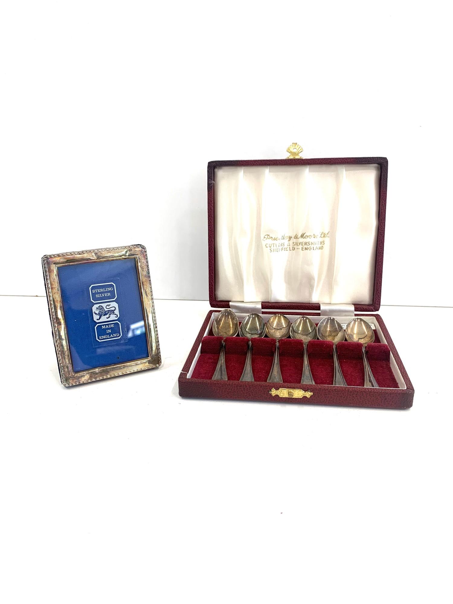 Boxed set of silver hallmarked tea spoons, and a sterling silver picture frame