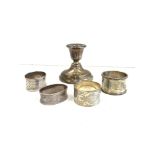 Selection of 4 silver hallmarked napkin rings and a silver candle stick approximate weight 247g