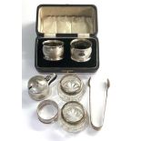 Selection of silver item includes salts sugar tongues napkin rings etc