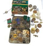 2 tins of miscellaneous cap badges medals etc