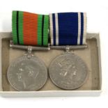 Boxed ER2 police exemplary service medal and defence medal, medal names constable John Law