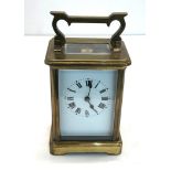 Vintage french brass carriage clock clock is ticking but no warranty given