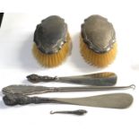 Selection of silver items includes silver back brushes button hook and shoe horns