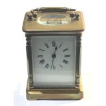 Brass carriage clock with key winds and ticks but no warranty given