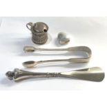 Selection of silver items includes mustard pot sugar tongues pill box and shoe horn