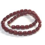 Barrel shaped cherry amber /bakelite bead necklace even sized beads measure each 15mm by 12mm