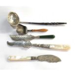 Selection of silver items includes ladle mother of pearl handle butter knives and sugar scoop please