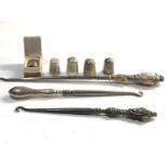 Selection of silver items includes thimbles and button hooks