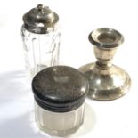 Selection of silver items includes squat candle stick and 2 antique silver top jars they measure