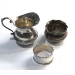 Selection of silver items includes cream jug napkin ring and small bowl