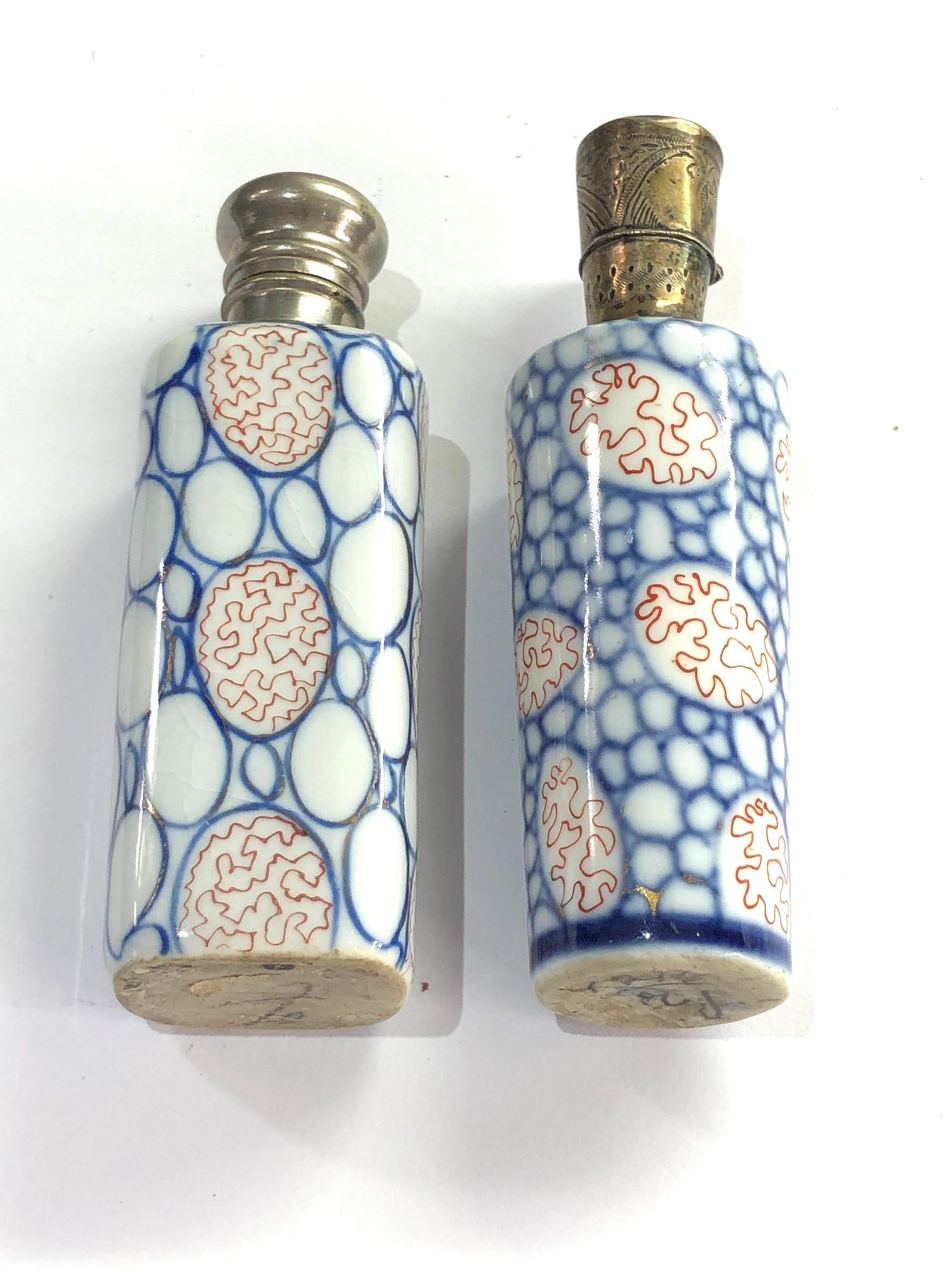 2 Antique dutch perfume bottles 1 with dutch silver sword hallmark the other not silver please