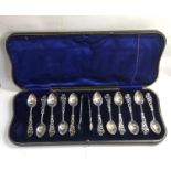 Set of 12 ornate silver tea spoons with sugar tongues Sheffield silver hallmarks