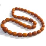 Antique egg yolk amber bead necklace even sized beads with larger central bead that measures