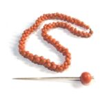 Antique coral bead necklace and 9ct & coral bead stick pin