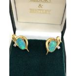 18ct opal and diamond earrings set with large fire opal each measures approx 12mm by 7mm with