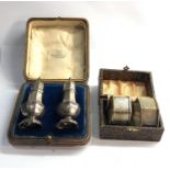 Vintage boxed silver peppers and pair of boxed silver napkin rings
